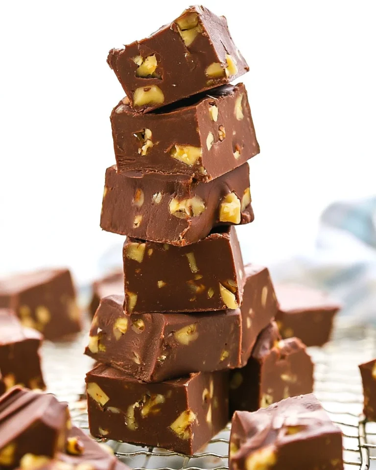 Delicious homemade Fantasy Fudge squares topped with nuts and chocolate.
