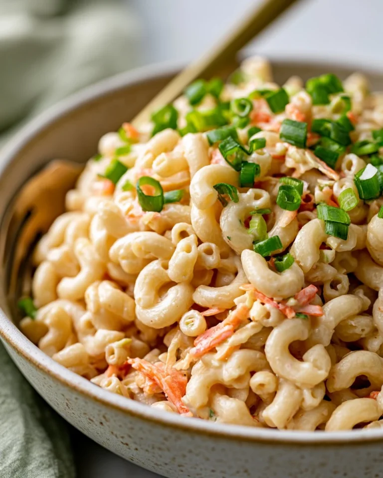 Delicious Hawaiian Macaroni Salad served in a bowl, garnished with herbs.
