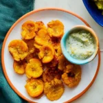 Crispy baked tostones served on a plate, golden and delicious.