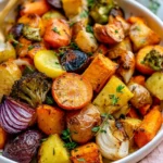 Bowl of easy roasted veggies featuring colorful bell peppers, carrots, and zucchini