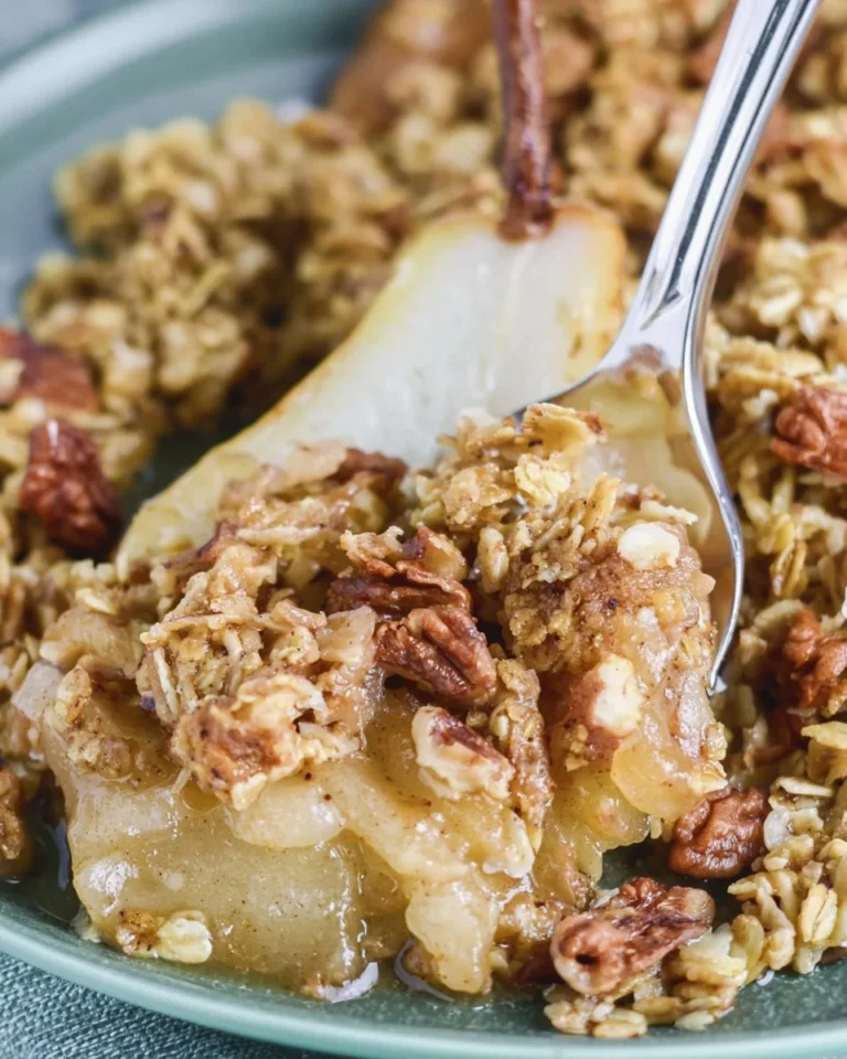 Delicious Holiday Pear Crumble served in a rustic dish, topped with golden brown crumble.