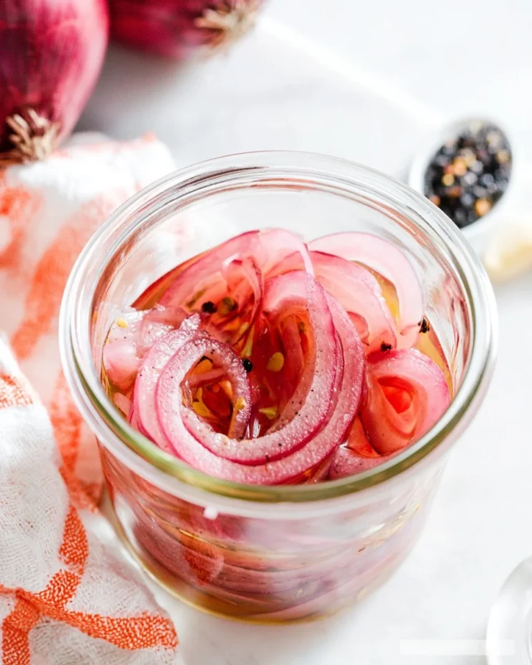 Bowl of quick pickled red onions ready to serve as a savory condiment.