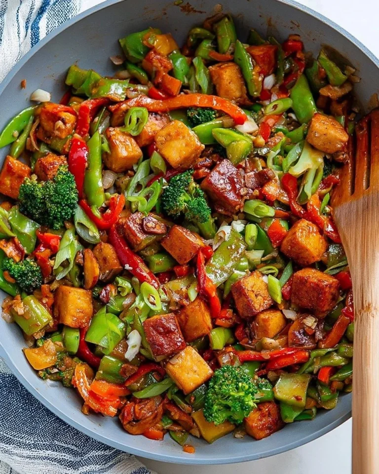 Colorful tofu stir fry with vegetables in a skillet